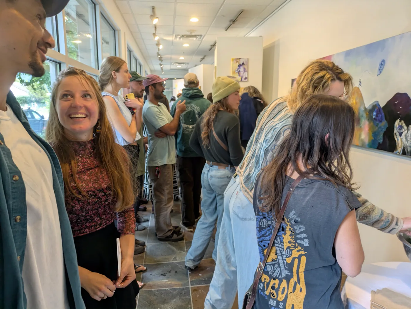 Guests viewing paintings at the opening