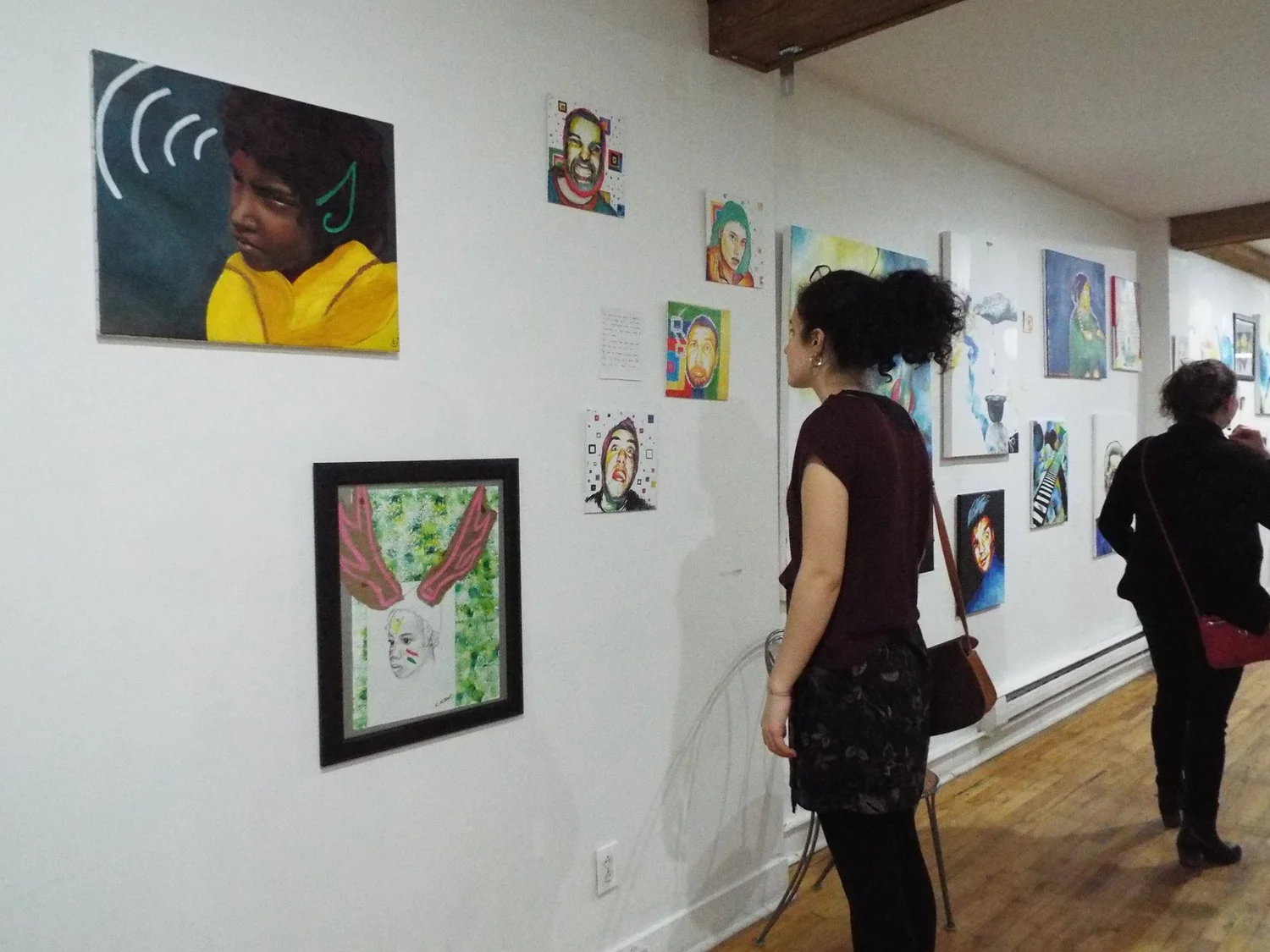 visitors viewing art on the gallery wall