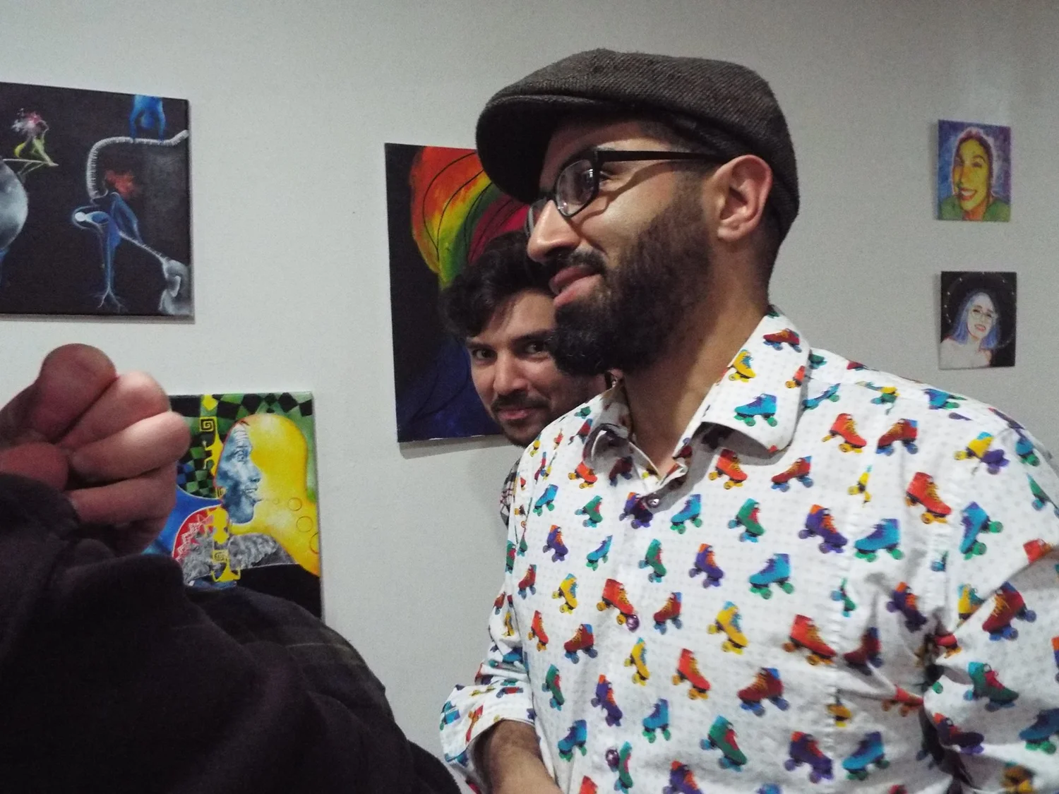 Karim in front of paintings