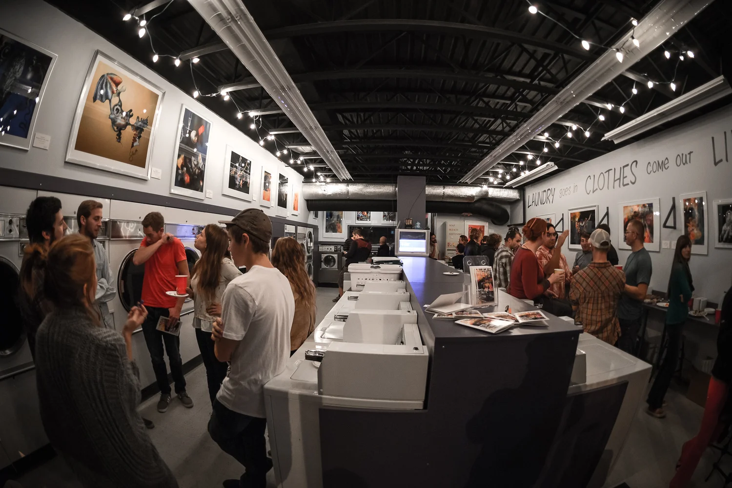 crowd viewing art at Lux Laundromat