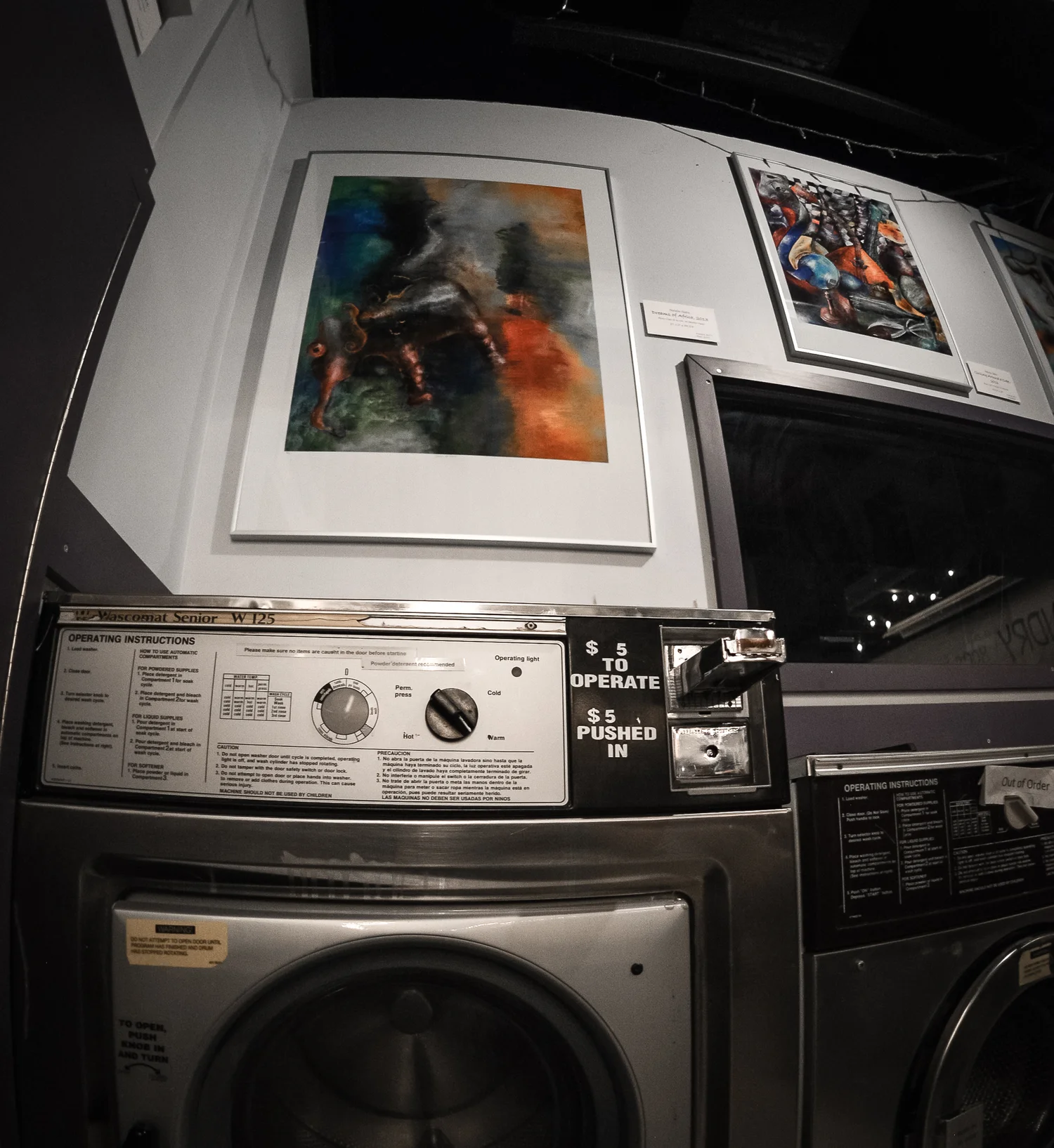 paintings hung above the washing machines