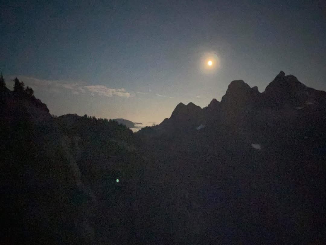 moonrise over mountain silhouettes