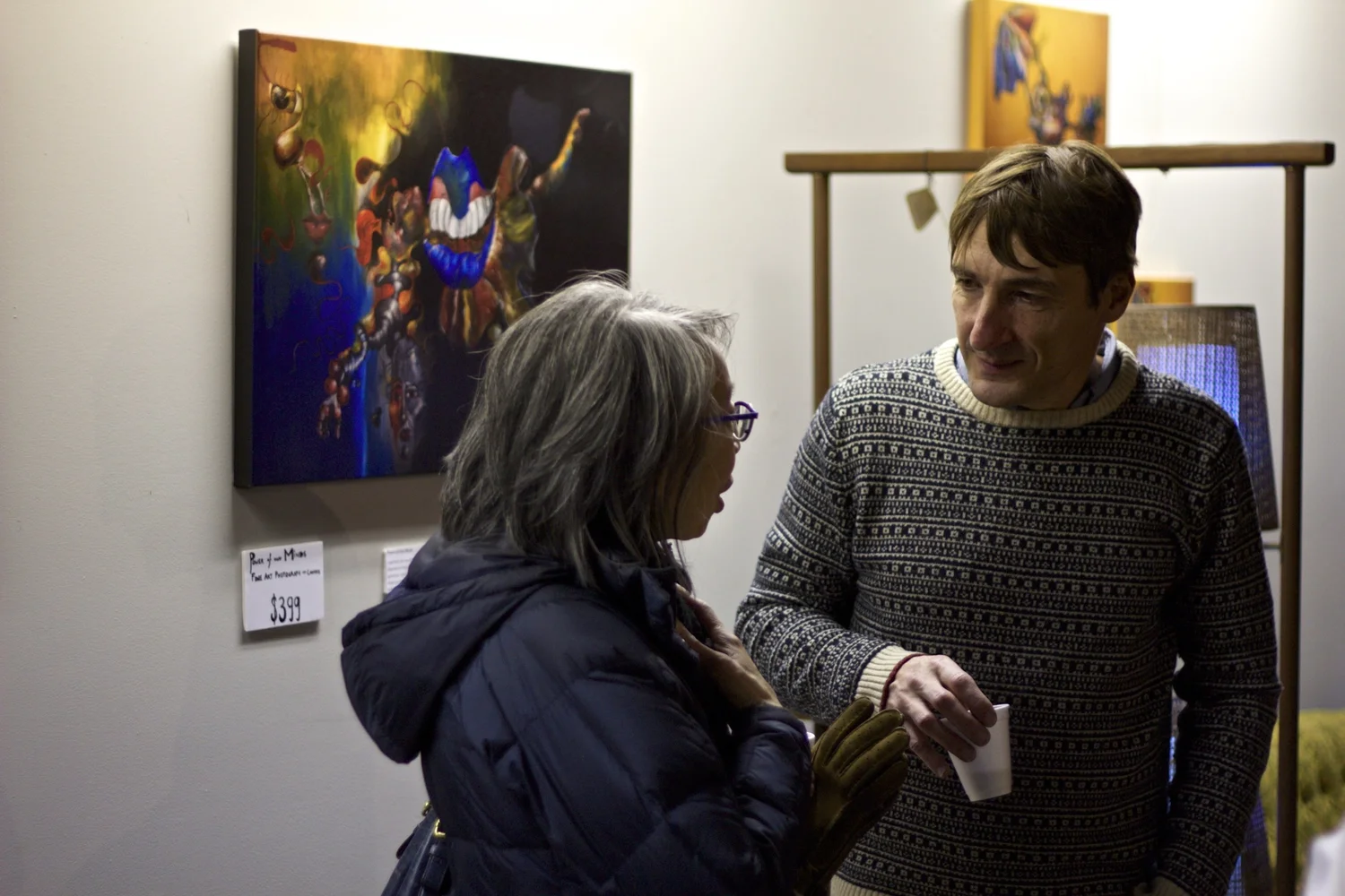 guests conversing in front of artwork