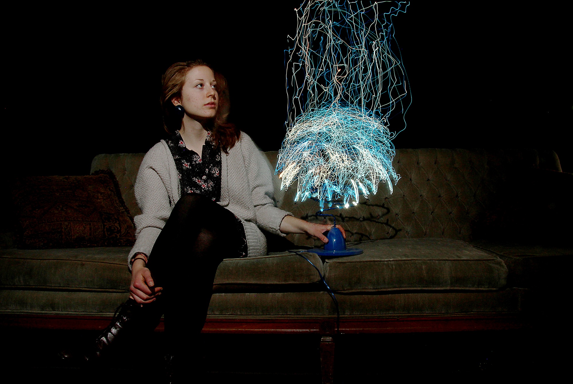 sitting on the gallery couch with a glowing electrostatic light sculpture