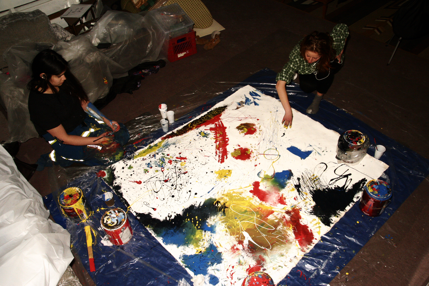 painting together surrounded by paint cans